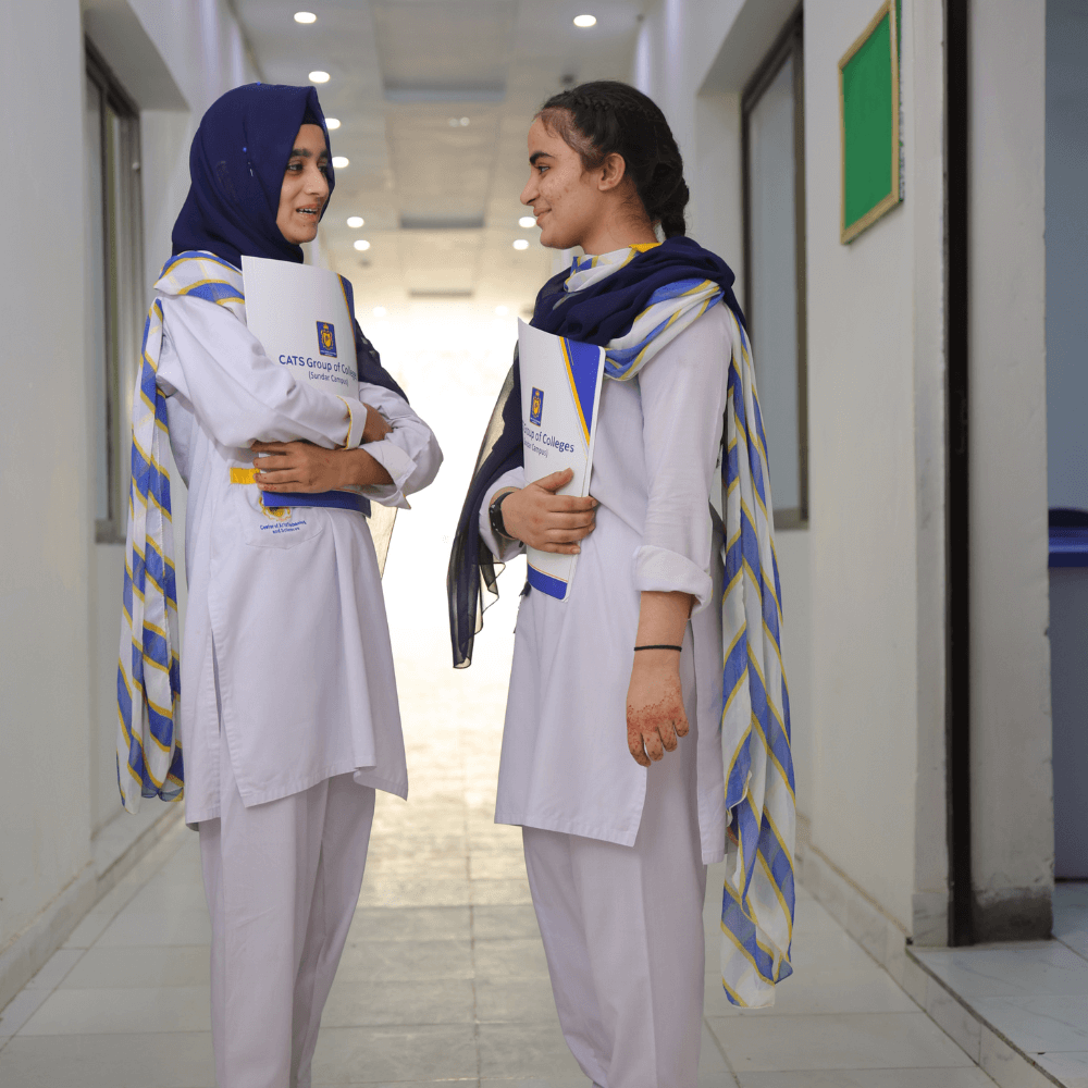 Two students of CATS College standing infront of the classrooms