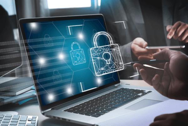 Digital padlock icon overlay on a laptop screen representing high-level cybersecurity and network data protection.