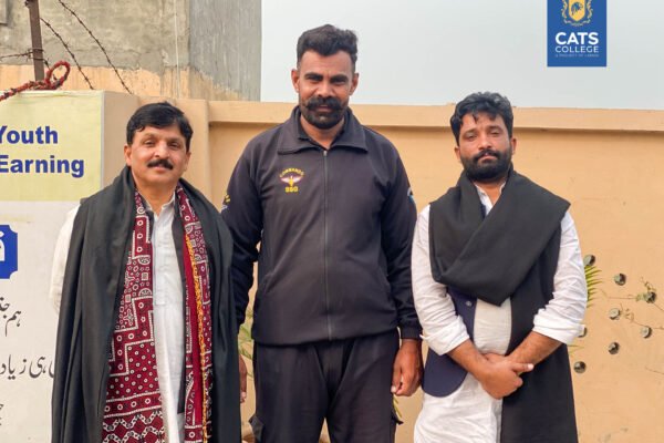 A cultural gathering at a premier intermediate college in Lahore featuring students in diverse regional dress, showcasing vibrant campus life.