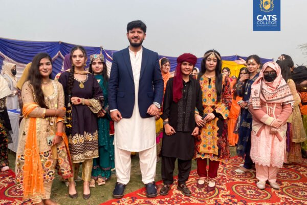 Vibrant student activities at an intermediate college in Lahore featuring traditional dance performances in a decorated campus hall.