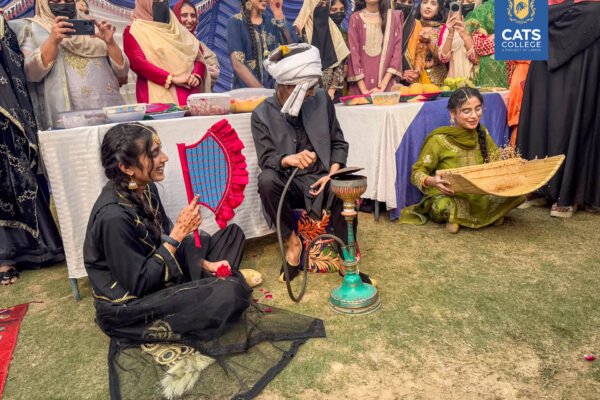 Vibrant student activities at an intermediate college in Lahore featuring traditional dance performances in a decorated campus hall.