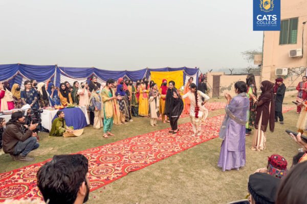 Vibrant student activities at an intermediate college in Lahore featuring traditional dance performances in a decorated campus hall.