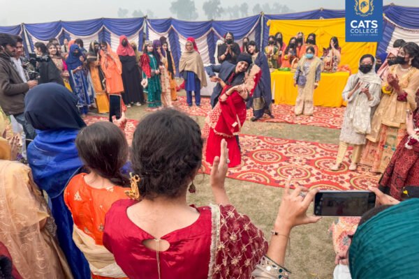 Faculty and students at one of the best colleges in Lahore posing in regional Khyber Pakhtunkhwa attire for a cultural festival.