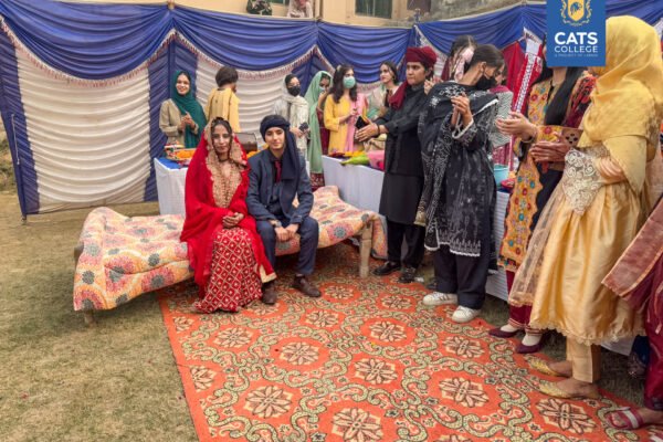 Faculty and students at one of the best colleges in Lahore posing in regional Khyber Pakhtunkhwa attire for a cultural festival.