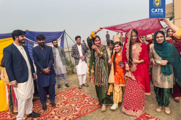 A cultural gathering at a premier private college in Lahore featuring students in regional dress, highlighting diverse degree programs in Lahore.