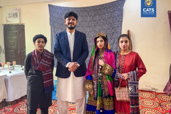 Faculty and students at one of the best colleges in Lahore posing in regional dress, with admissions open in Lahore colleges for new sessions.