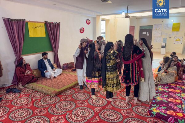 CATS College students enjoying a traditional cultural feast, highlighting the community for BS degree programs in lahore.