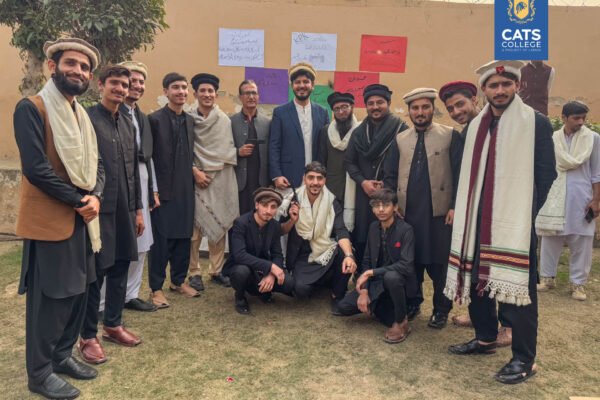 Faculty and students in traditional Sindhi Ajrak at a CATS College cultural feast, highlighting campus life for admission open in cats college 2026.