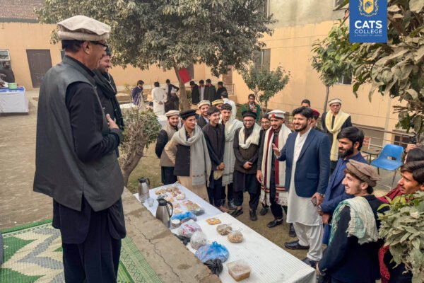 A senior faculty member addressing students in traditional attire at CATS College, emphasizing the community within BS degree programs in lahore and NAVTTC affiliated courses in lahore.