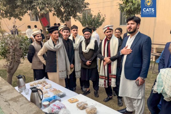 CATS College students gathered around a traditional refreshment table during a cultural day, highlighting student community for those interested in BS degree programs in lahore and diploma courses after matric in pakistan.