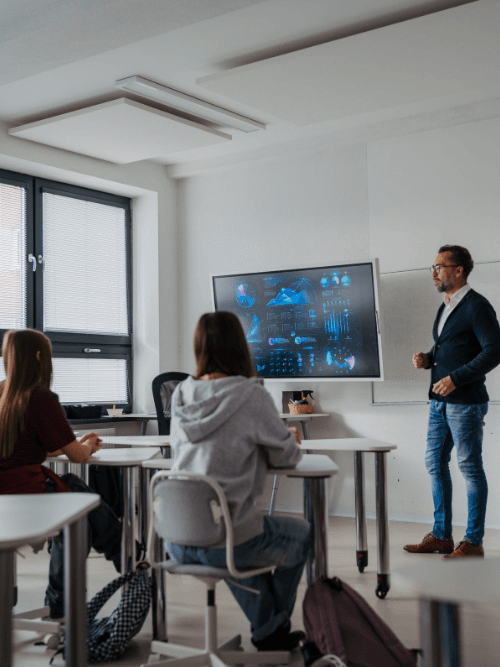 Instructor at CATS using a digital display to present data analysis and logical reasoning concepts to students.