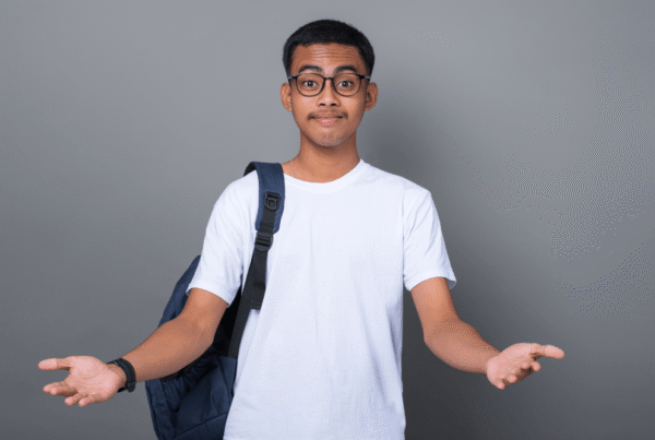 CATS student shrugging with a backpack, looking unsure about education or career choice