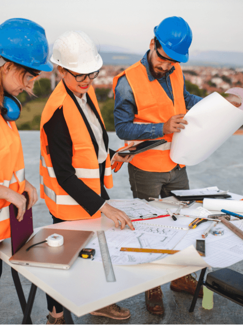 Civil engineering and architecture students reviewing construction blueprints, showcasing career-oriented training at CATS (College of Admission Tests).